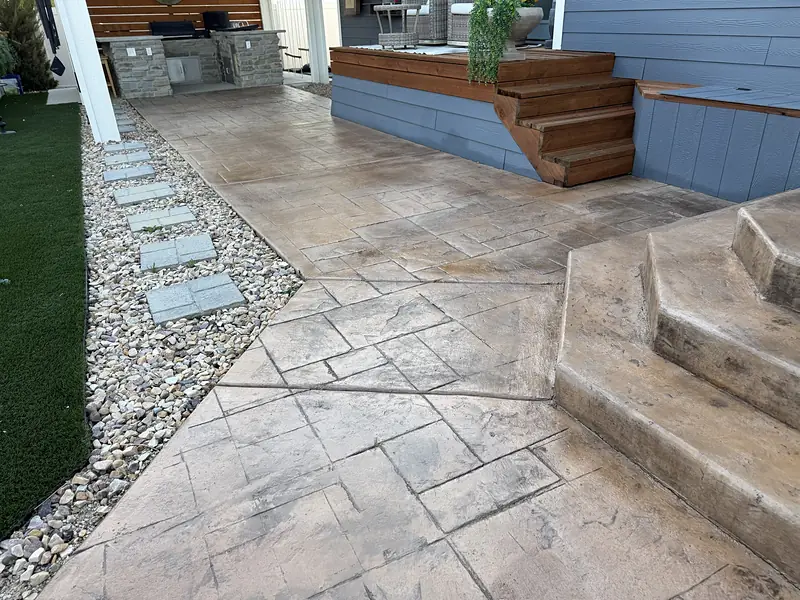 Sealed stamped concrete walkway leading to outdoor kitchen